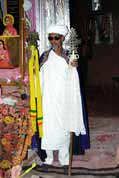 Stone church at Lalibela. Priest shows holy crosses. Ethiopia.