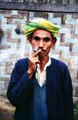 Local man (from hill tribe) is smoking traditional burma cigar called cheroot. Area around Kalaw village. Myanmar (Burma).