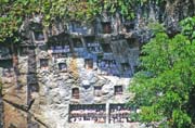 Traditional graves at Lemo village. Tau tau figures can be seen at galleries in front of graves. Tana Toraja area. Indonesia.