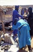 Tuaregs at market. One of them is watching salt plates. They have been transported to Dj�bok village from middle of Sahara, from salt mines at Taoudenni. Mali.