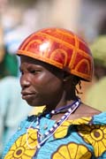 Woman at Tourou village at Mandara Mountains. Local fashion is red wooden calabashes on women' heads. They look rather like army helmets and which indicate things like their marital status. Cameroon.