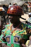 Woman at Tourou village at Mandara Mountains. Local fashion is red wooden calabashes on women' heads. They look rather like army helmets and which indicate things like their marital status. Cameroon.
