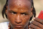 Man from nomadic Wodaab� tribe (also called Bororo) prepares himself for Yaake dance. Gerewol festival. Niger.