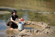 Getting drinking water - primitive filtration of river water. Camp with working elephants. Taungoo town area. Myanmar (Burma).