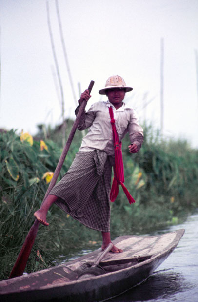 Traditional canoe paddling by leg. Man from Intha tribe. Inle lake. Myanmar (Burma).