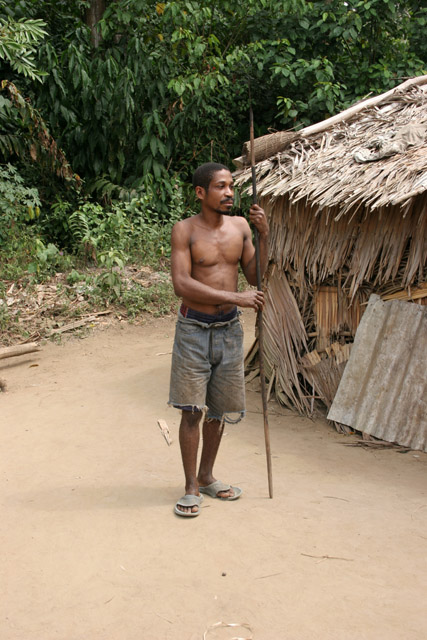 Pygmy hunter, village down to the Lobe River. The Pygmy people are gatherers and hunters. They hunt animals such as antelopes, pigs and monkeys, and also gather honey, wild yams, berries and other plants. Cameroon.
