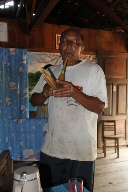 Traditional flute. Lahu family during their Lahu New Year celebration, area around Kengtung town. Myanmar (Burma).